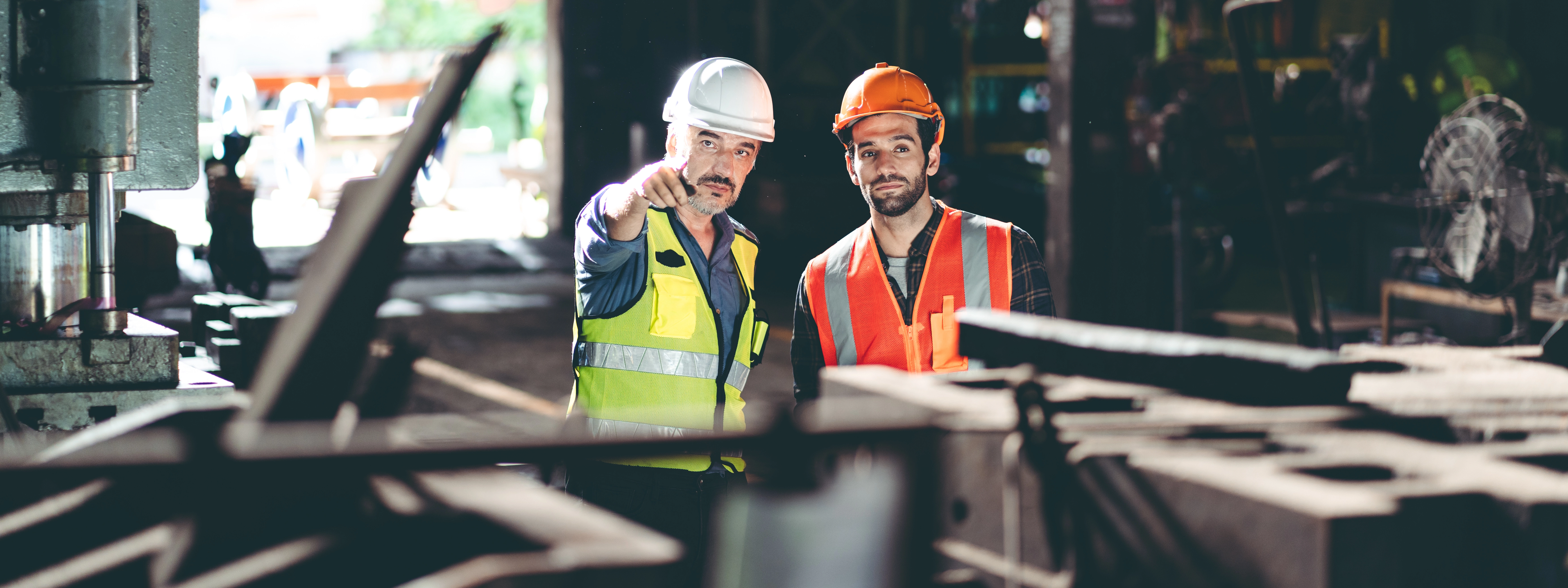 Image of contractors discussing work and pointing at a solution.